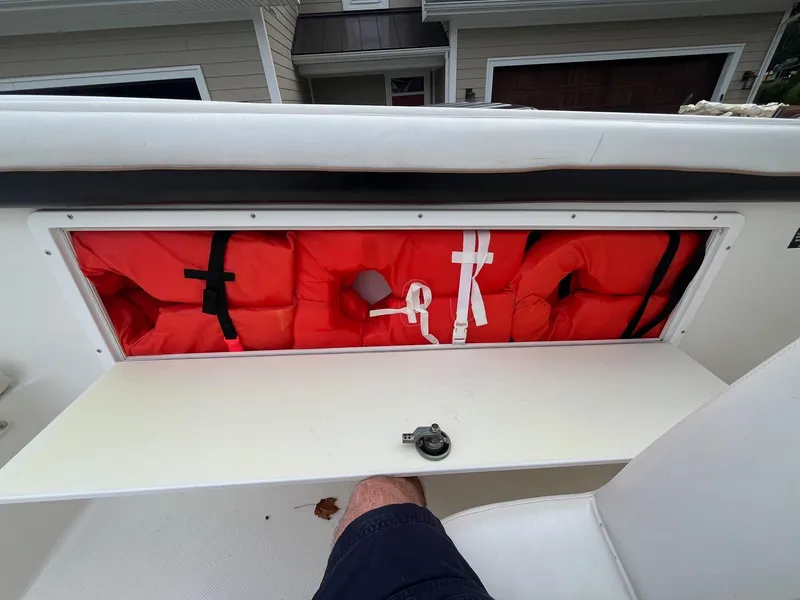 Slide: The Image of Storage compartment with life jackets on a 2000 Wellcraft 302 SCARAB SPORT boat. - 21