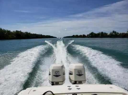 Slide: The Image of Wellcraft 302 SCARAB SPORT 2000 speeding on a clear blue waterway, leaving a wake trail. - 4