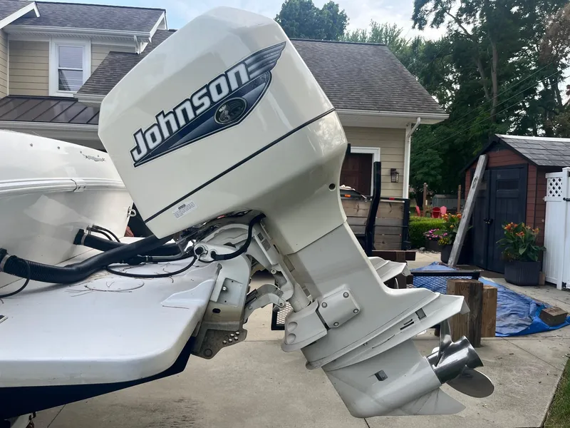 Slide: The Image of Outboard motor on a 2000 Wellcraft 302 SCARAB SPORT boat, featuring Johnson branding. - 8