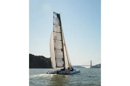 Slide: The Image of Sailing Marstrom Seacart 30 catamaran on open water, 2005 model, with bridge in background. - 15