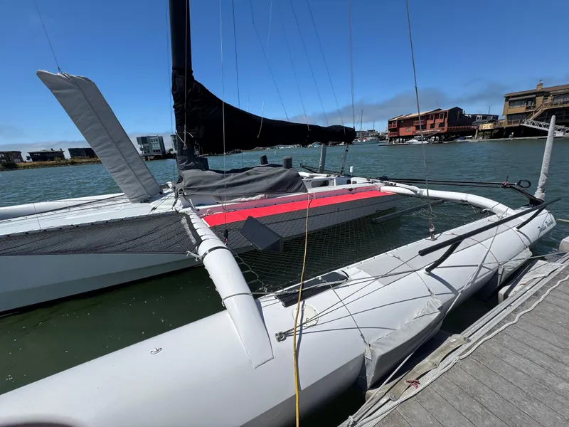 Slide: The Image of 2015 Marstrom Seacart 30 trimaran docked by the waterfront on a sunny day. - 2