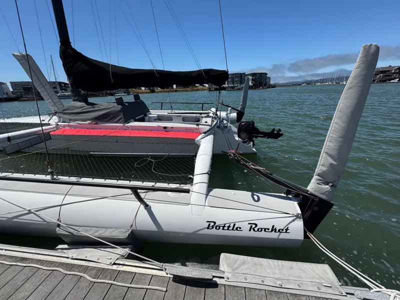 Slide: The Image of 2015 Marstrom Seacart 30 trimaran named "Bottle Rocket" docked at a marina. - 4