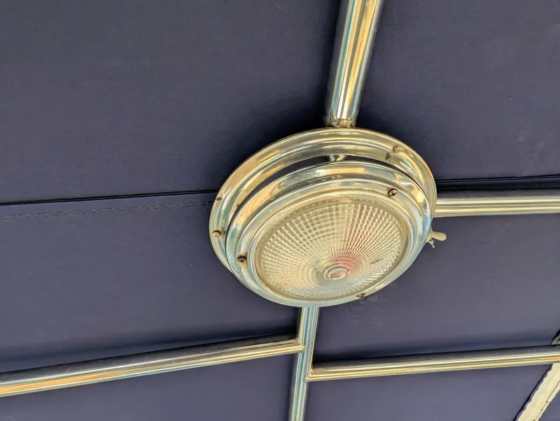 Slide: The Image of Ceiling light fixture on a 2004 Duffy 21 boat with metal framework. - 3