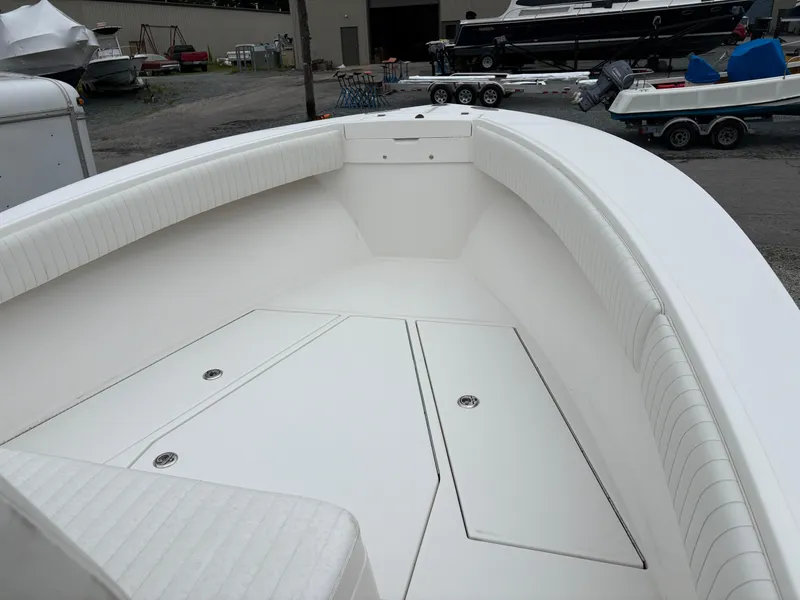 Slide: The Image of 2005 Regulator 24 Classic boat interior with white seating and storage compartments. - 10