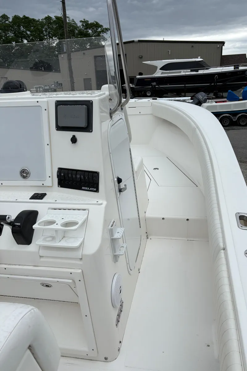 Slide: The Image of 2005 Regulator 24 Classic boat interior with control panel and seating area. - 11