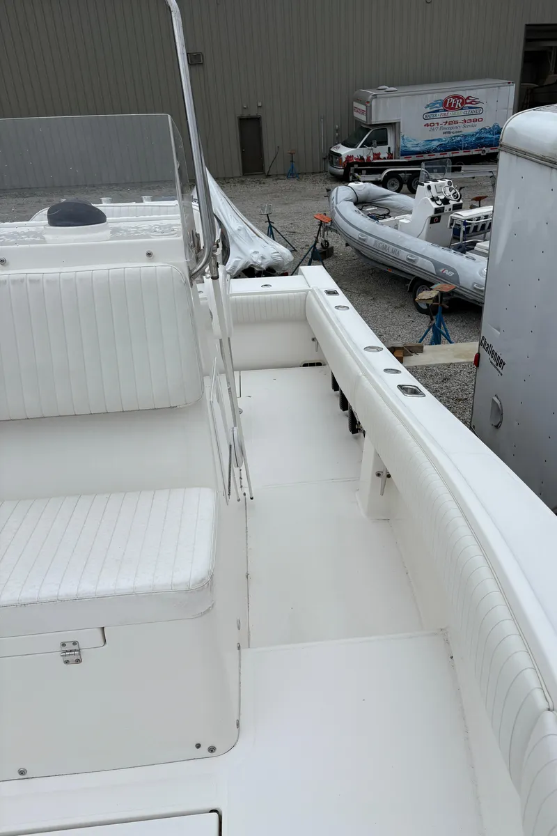 Slide: The Image of 2005 Regulator 24 Classic boat interior with white seating and deck. - 13
