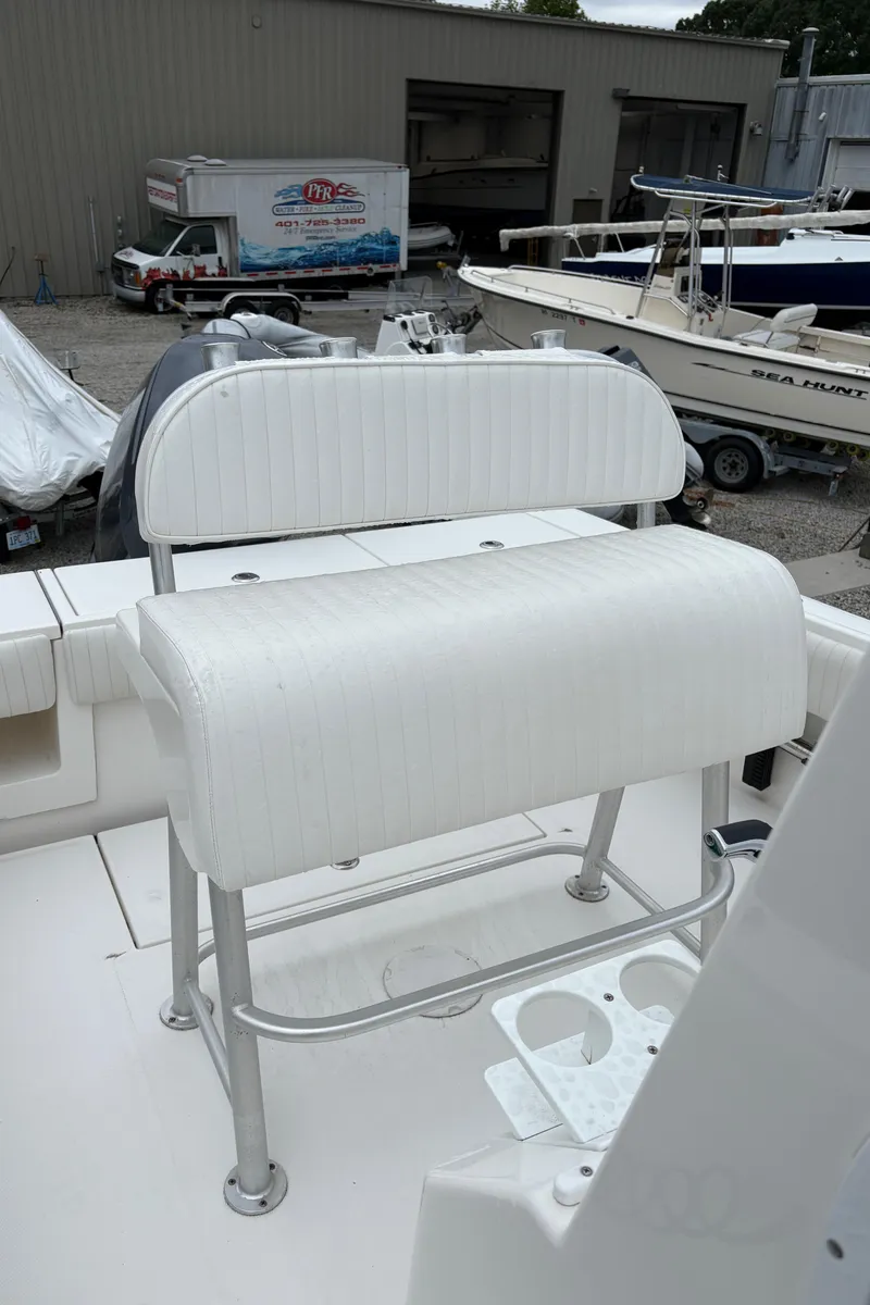 Slide: The Image of 2005 Regulator 24 Classic boat interior with white seating and cup holders. - 14