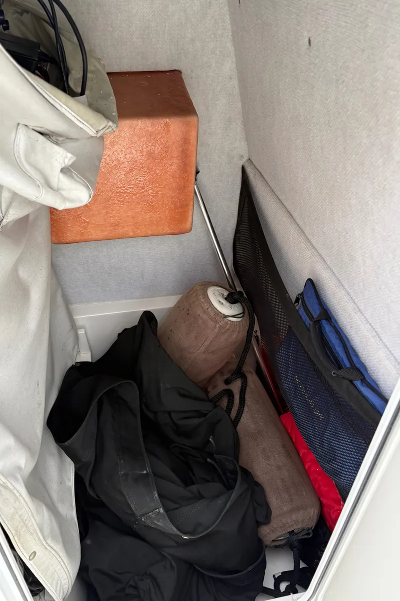 Slide: The Image of Storage compartment in a 2005 Regulator 24 Classic boat with various items. - 16