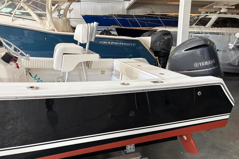 Slide: The Image of 2005 Regulator 24 Classic boat with Yamaha outboard motor in showroom. - 4