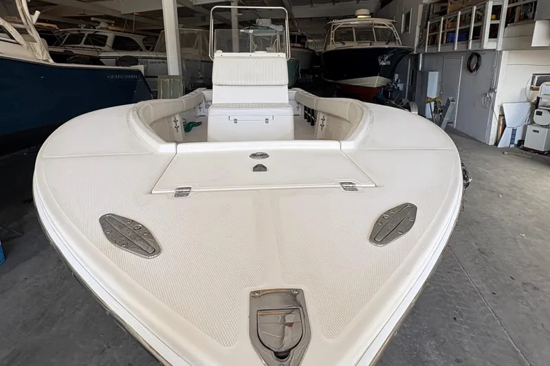 Slide: The Image of 2005 Regulator 24 Classic boat in storage, showcasing spacious deck and seating area. - 5