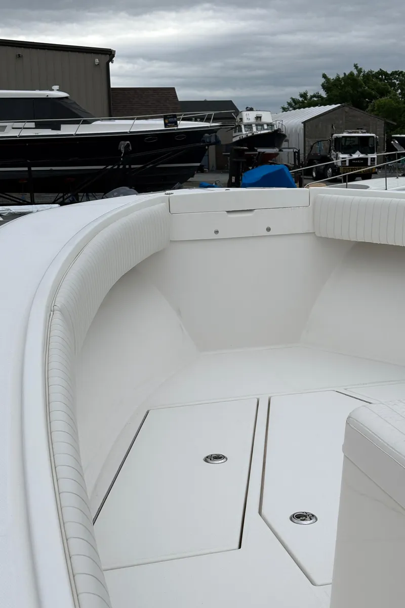 Slide: The Image of 2005 Regulator 24 Classic boat interior with white seating and storage compartments. - 9