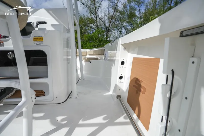 Slide: The Image of 2023 Sea Pro 219 Deep V CC boat interior with white deck and storage compartments. - 5