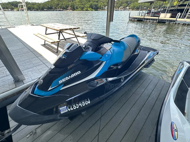 The Image of 2017 Sea-Doo RXT 260 jet ski docked by a scenic lake. - 0