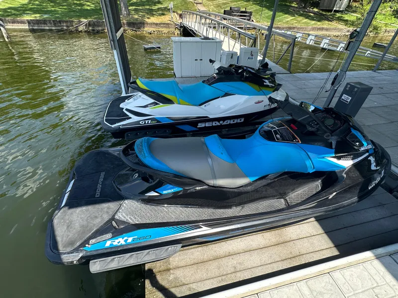 Slide: The Image of 2017 Sea-Doo RXT 260 jet ski docked beside another watercraft. - 4