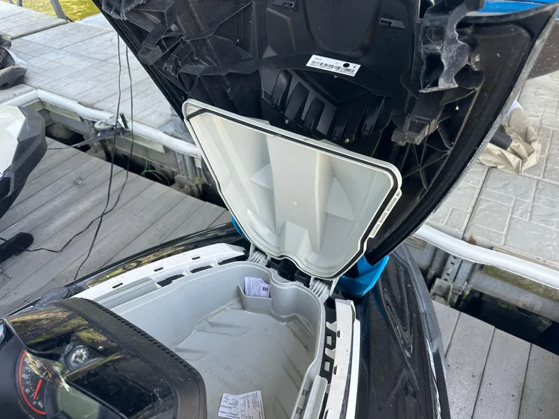 Slide: The Image of Open storage compartment of a 2017 Sea-Doo RXT 260 on a dock. - 7