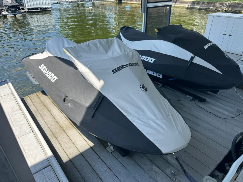 Slide: The Image of 2017 Sea-Doo RXT 260 jet skis covered on a dock by the water. - 9