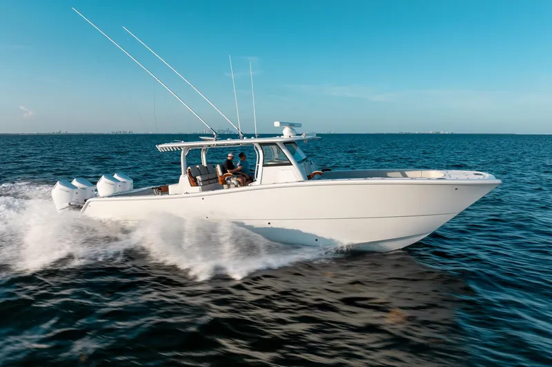 Slide: The Image of 2023 Freeman 43 boat cruising on open water under clear blue sky. - 15