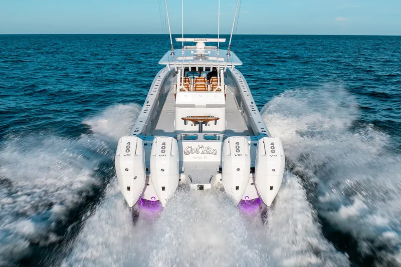 Slide: The Image of 2023 Freeman 43 boat speeding on open ocean with four powerful outboard engines. - 17
