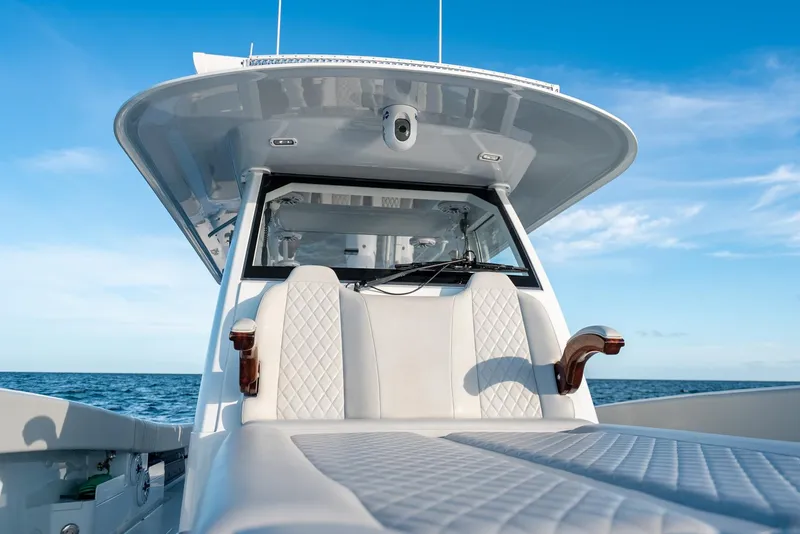 Slide: The Image of 2023 Freeman 43 boat with luxurious seating, cruising on open sea under clear blue sky. - 37