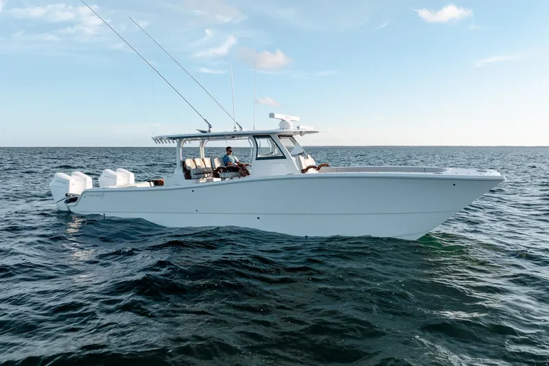 Slide: The Image of 2023 Freeman 43 boat on open water, featuring sleek design and multiple outboard engines. - 4