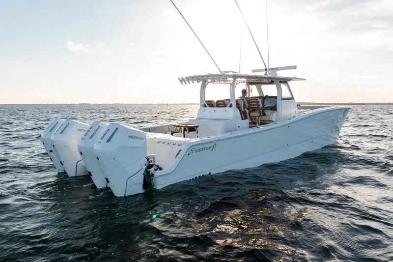 Slide: The Image of 2023 Freeman 43 boat on open water, featuring powerful Mercury engines. - 5