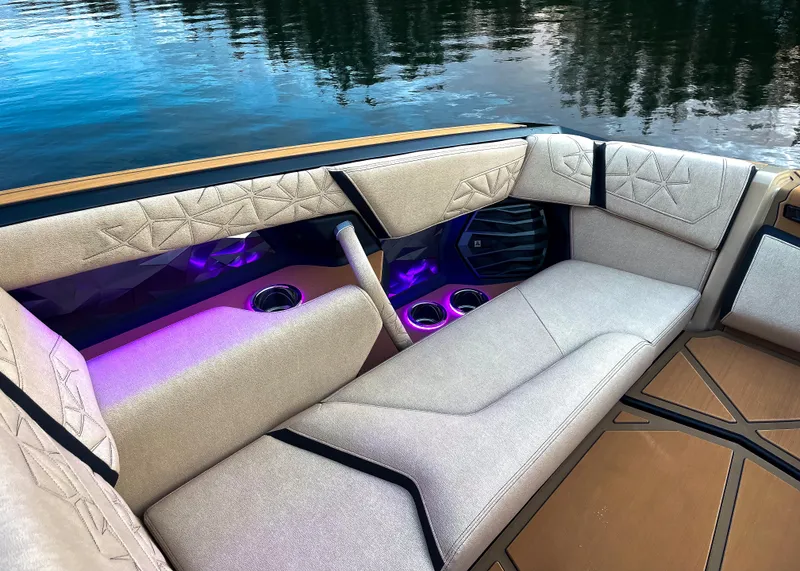 Slide: The Image of Luxurious interior of 2026 Nautique Paragon G25 boat with ambient lighting. - 10
