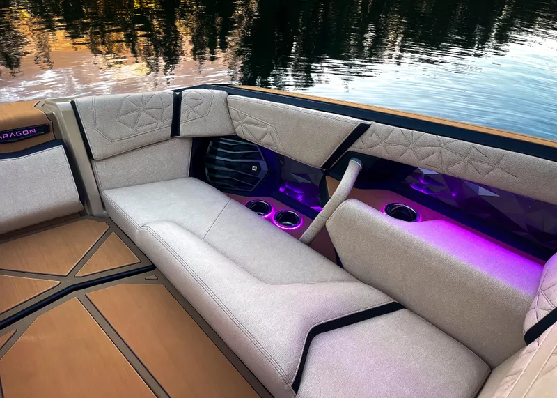 Slide: The Image of Luxurious interior of 2026 Nautique Paragon G25 boat with ambient lighting and plush seating. - 11