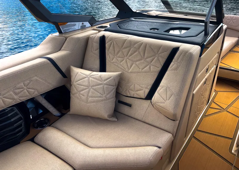 Slide: The Image of Luxurious interior of 2026 Nautique Paragon G25 boat with beige seating and geometric patterns. - 13