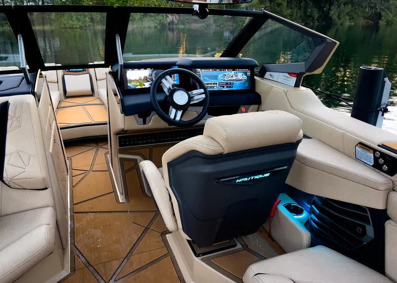 Slide: The Image of 2026 Nautique Paragon G25 interior with modern dashboard and luxurious seating. - 8
