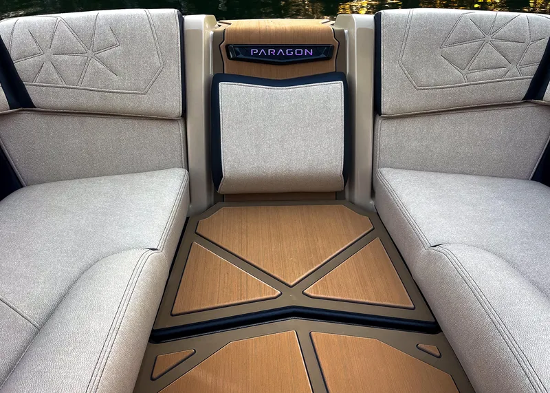 Slide: The Image of Interior of 2026 Nautique Paragon G25 boat with luxurious seating and stylish flooring. - 9