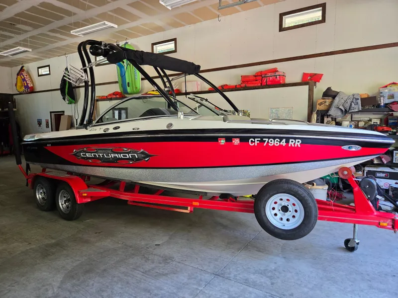 Slide: The Image of 2009 Centurion Air Warrior Elite V-Drive C4 boat on trailer in garage. - 16