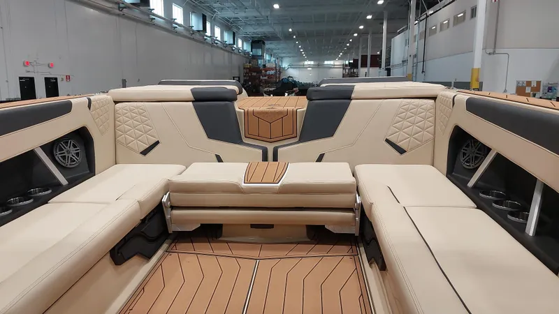 Slide: The Image of 2025 Nautique GS24 boat interior with luxurious beige seating and modern design. - 11