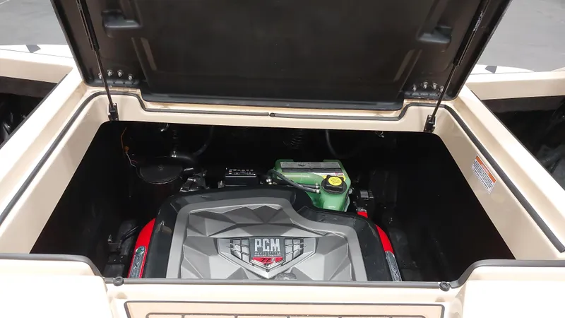 Slide: The Image of 2025 Nautique GS24 engine compartment with PCM engine visible under open hatch. - 13