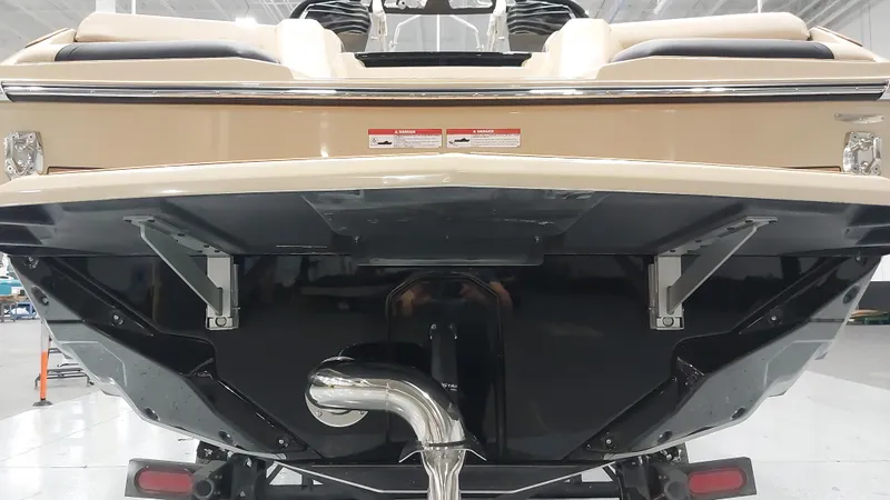 Slide: The Image of 2025 Nautique GS24 boat rear view in a showroom setting. - 15