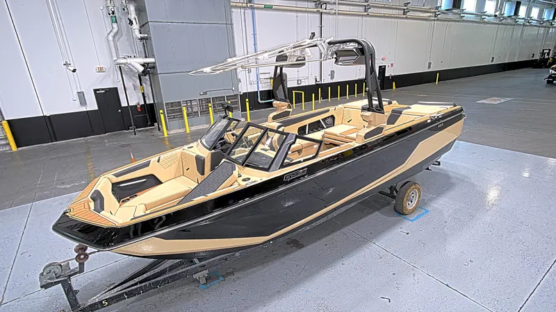 Slide: The Image of 2025 Nautique GS24 boat in a warehouse, featuring sleek design and modern amenities. - 4