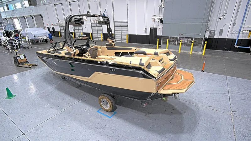 Slide: The Image of 2025 Nautique GS24 boat in a warehouse, showcasing sleek design and modern features. - 5
