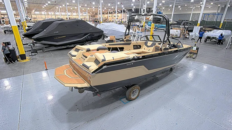 Slide: The Image of 2025 Nautique GS24 boat in a showroom, showcasing sleek design and luxury features. - 7