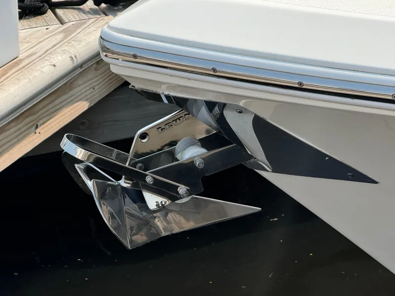 Slide: The Image of 2023 Cobia 301 CC boat anchor detail at dockside. - 7