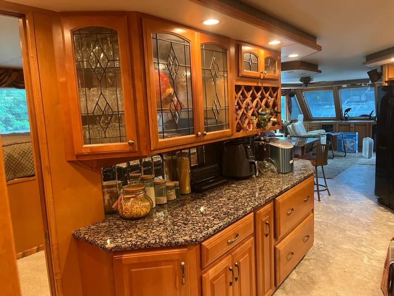 Slide: The Image of Luxurious kitchen interior on a 2003 Majestic 90 X 18 yacht with wooden cabinets. - 27