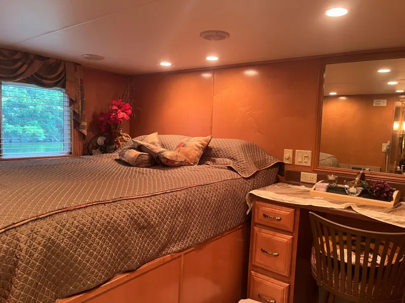 Slide: The Image of Luxurious bedroom interior in a 2003 Majestic 90 X 18 houseboat, featuring elegant decor and lighting. - 32