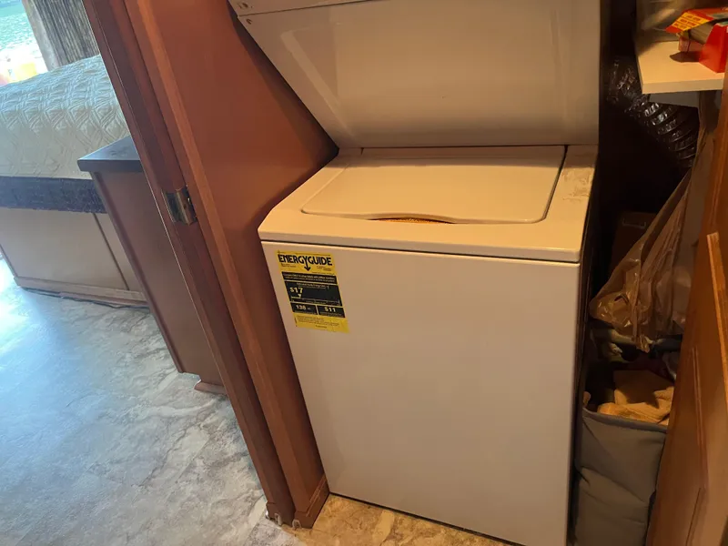 Slide: The Image of Compact white washing machine in a cozy room, featuring an EnergyGuide label. - 35