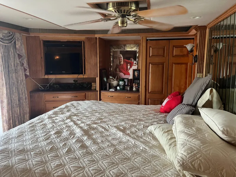 Slide: The Image of Luxurious bedroom with wooden decor, ceiling fan, and cozy bedding in a Majestic 90 X 18, 2003. - 37