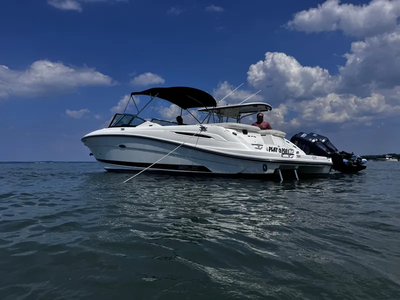 Slide: The Image of 2007 Sea Ray 270 SLX boat on calm water under a partly cloudy sky. - 4