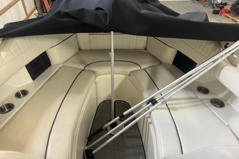 Slide: The Image of 2007 Sea Ray 270 SLX boat interior with white seating and cup holders. - 26