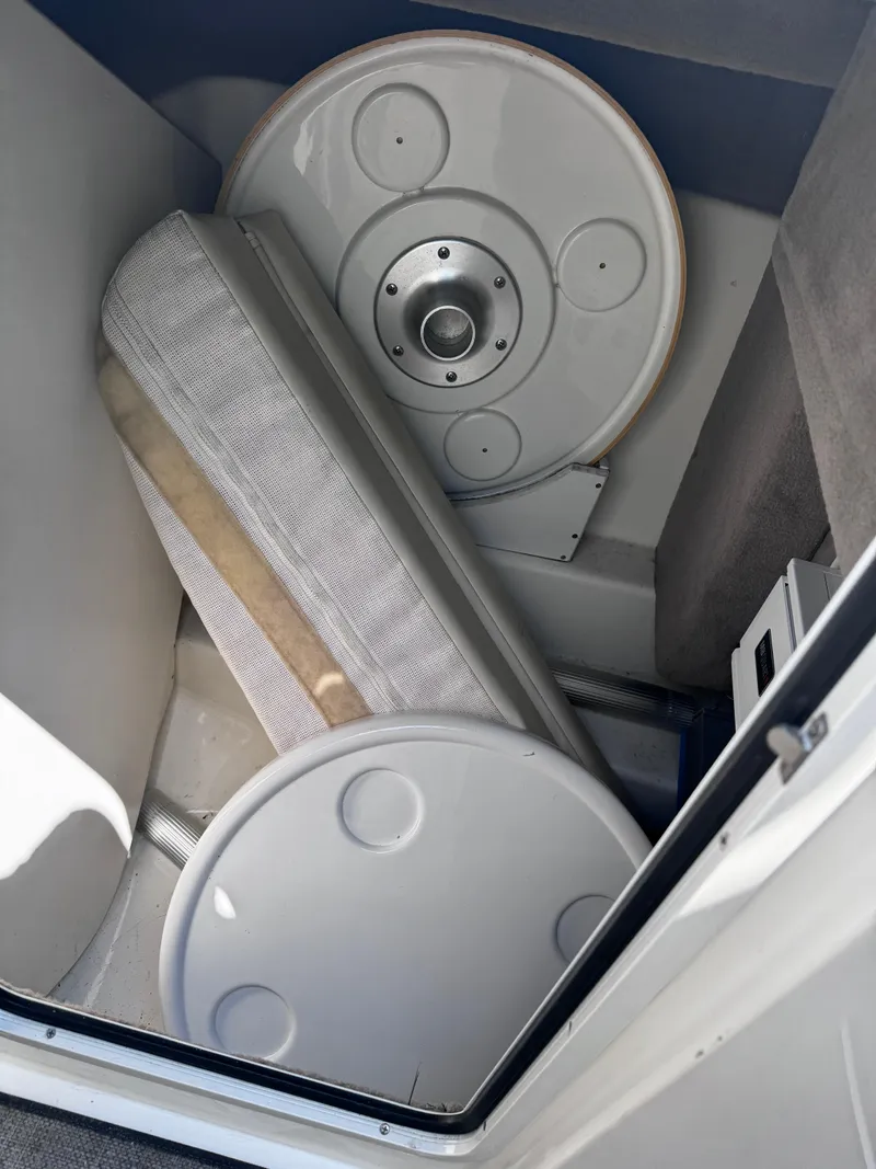 Slide: The Image of Storage compartment in a 2007 Sea Ray 270 SLX boat with round table and cushion. - 16