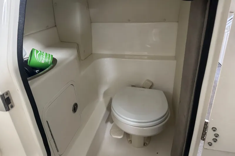 Slide: The Image of 2007 Sea Ray 270 SLX boat bathroom with toilet and storage compartment. - 37