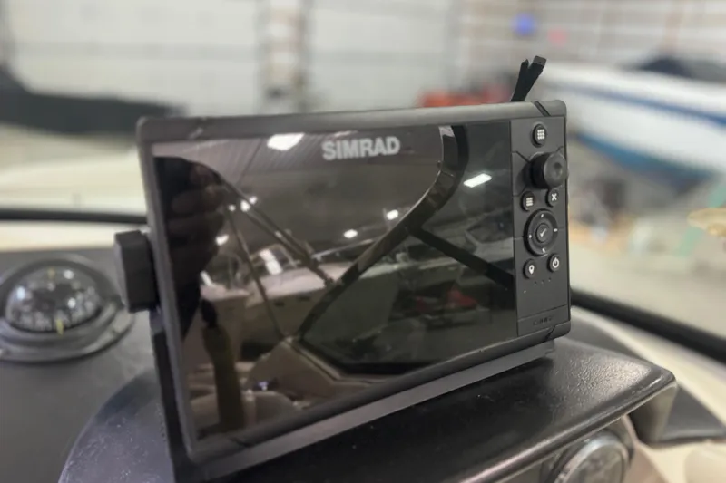 Slide: The Image of Simrad marine display on 2007 Sea Ray 270 SLX dashboard in a boat garage. - 12