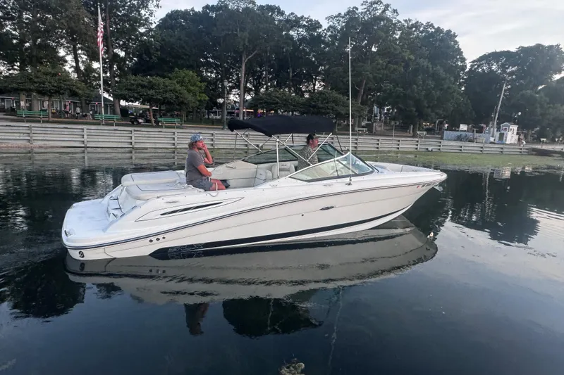 Slide: The Image of 2007 Sea Ray 270 SLX boat on calm water near a wooden dock. - 40