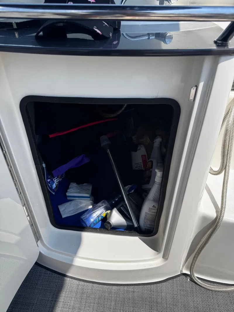 Slide: The Image of Open storage compartment on 2007 Sea Ray 270 SLX boat with various items inside. - 18