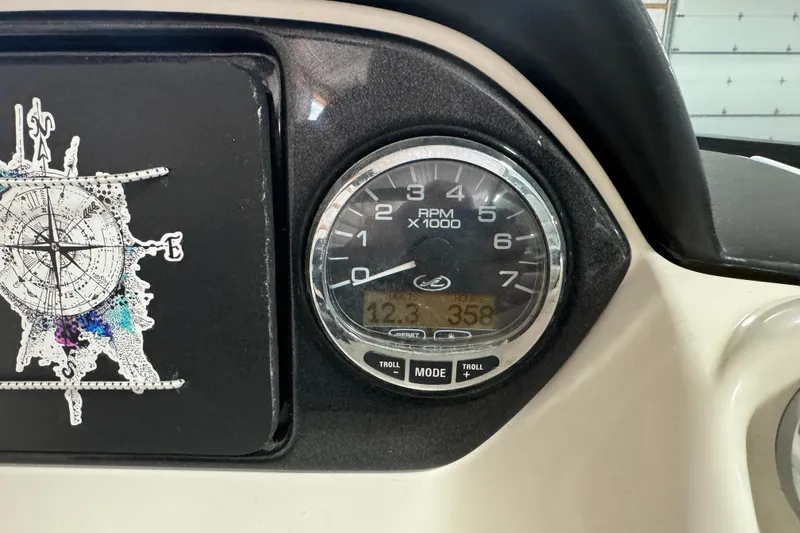Slide: The Image of Dashboard of a 2007 Sea Ray 270 SLX boat showing RPM gauge and compass design. - 10